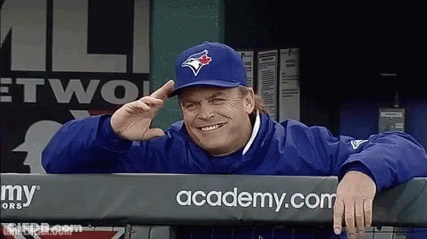 Man In Blue Jays Hat Leaning Over Fence GIF
