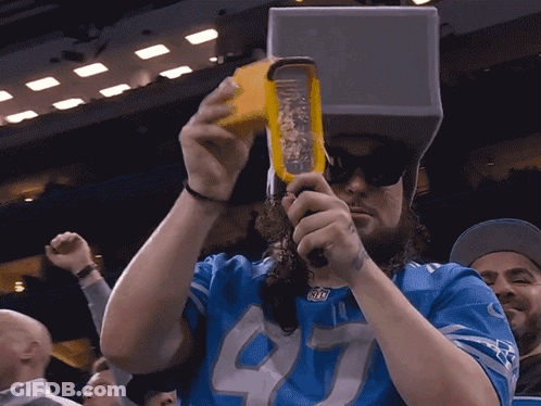 Man In Blue Jersey Number 40 Grating Cheese GIF