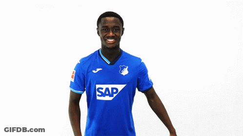 Man In Blue Jersey With Letter T Smiling GIF