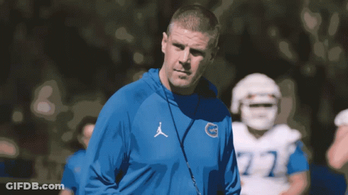 Man In Blue Jordan Sweatshirt In Front Of Football Player GIF