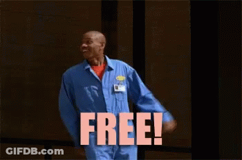 Man In Blue Jumpsuit Standing Before Free Sign GIF