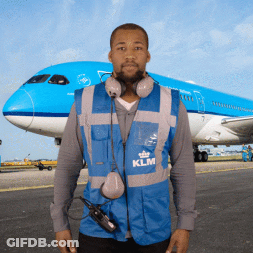 Man In Blue KLM Vest In Front Of Plane GIF