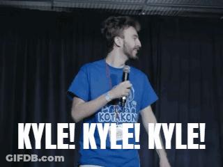 Man In Blue Kotakon Shirt Holding Microphone Saying Kyle GIF