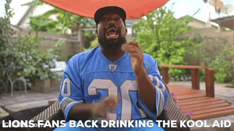 Man In Blue Lions Jersey Sitting In Chair GIF