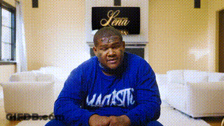 Man In Blue Majestic Sweatshirt Sitting On Floor GIF