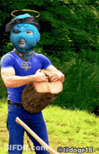 Man In Blue Mask Holding Log And Shovel GIF