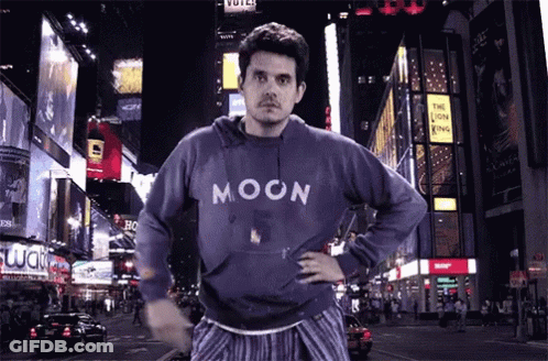 Man In Blue Moon Sweatshirt On Night Street GIF