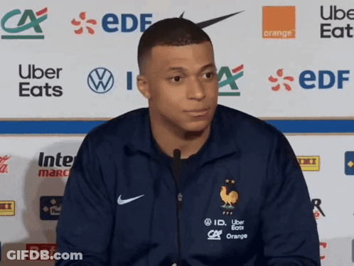 Man In Blue Nike Jacket In Front Of Uber Eats And EDF Logos GIF