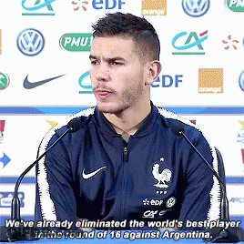 Man In Blue Nike Jacket Speaking Into Microphone GIF
