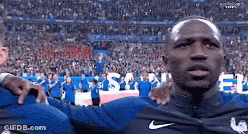 Man In Blue Nike Shirt In Front Of Crowd GIF