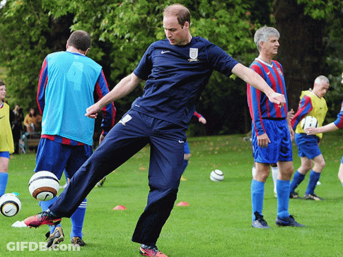 Man In Blue Nike Shirt Kicking Soccer Ball GIF