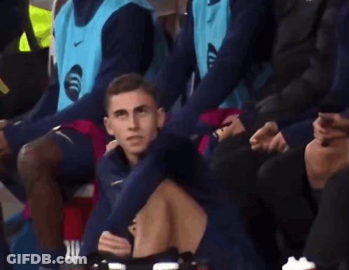 Man In Blue Nike Vest Sitting In Stadium GIF