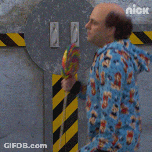 Man In Blue Onesie Holding Lollipop GIF