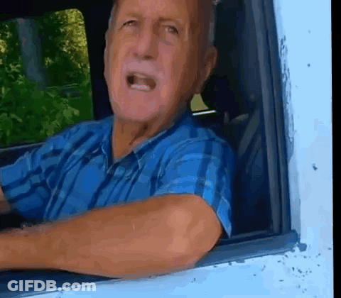 Man In Blue Plaid Shirt Looking Out Car Window GIF
