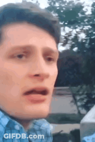 Man In Blue Plaid Shirt Making Funny Face GIF
