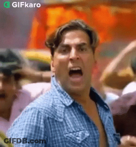 Man In Blue Plaid Shirt Screaming In Crowd GIF