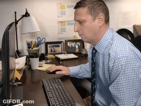 Man In Blue Plaid Shirt Using Keyboard GIF