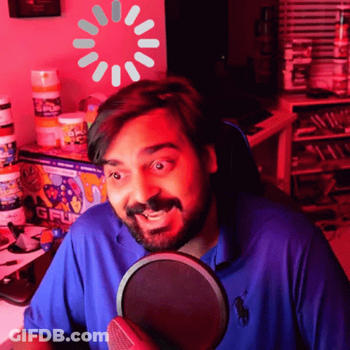 Man In Blue Polo Shirt At Microphone With Loading Screen GIF