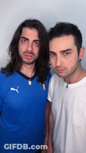 Man In Blue Puma Shirt Next To Man In White GIF