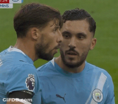 Man In Blue Puma Shirt Talking To Another Man GIF