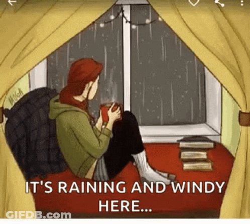 Man In Blue Raincoat Kneeling In Grass GIF