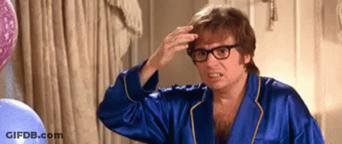 Man In Blue Robe And Glasses Touching Hair GIF