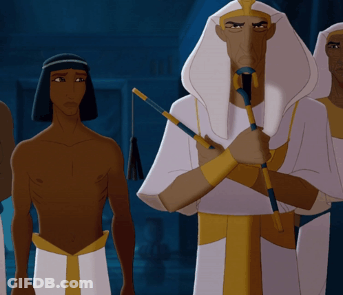 Man In Blue Robe And Hat In Front Of Building GIF