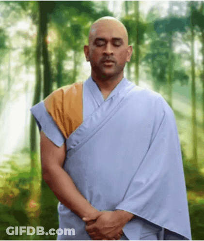 Man In Blue Robe Meditating In Woods GIF