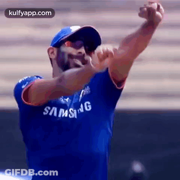 Man In Blue Samsung Shirt And Blue Hat Throwing Ball GIF