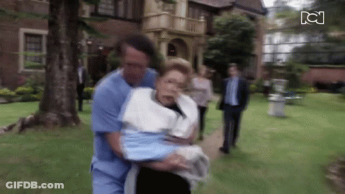 Man In Blue Scrub Carrying Woman In White Towel GIF
