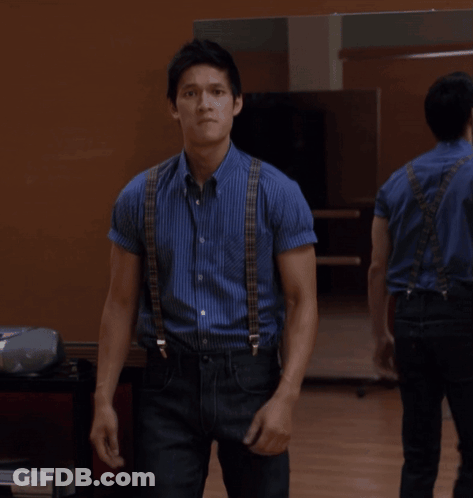 Man In Blue Shirt And Black Jeans Standing Before Mirror GIF
