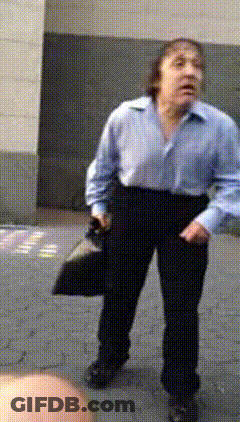 Man In Blue Shirt And Black Pants Holding Hat GIF
