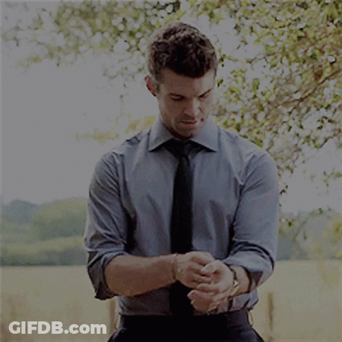 Man In Blue Shirt And Black Tie Adjusting Cufflinks GIF