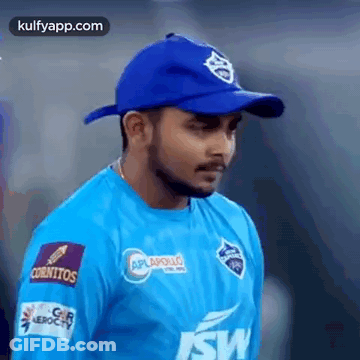Man In Blue Shirt And Blue Hat Standing On Field GIF