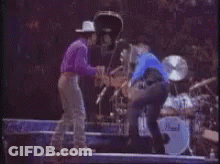 Man In Blue Shirt And Cowboy Hat By Motorcycle GIF