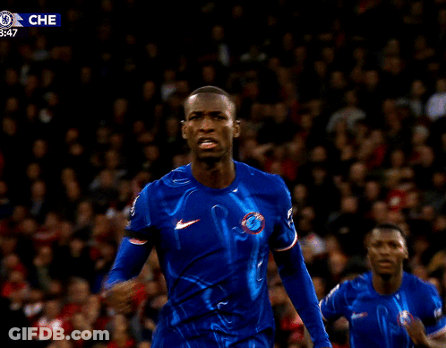 Man In Blue Shirt And Crowd With Che Logo GIF