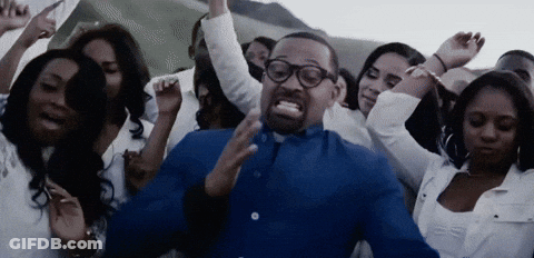 Man In Blue Shirt And Glasses Surrounded By Crowd Of Women GIF