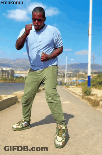 Man In Blue Shirt And Green Pants With Emakoran GIF