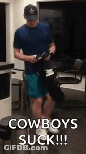 Man In Blue Shirt And Hat Holding Cowboy Boots GIF