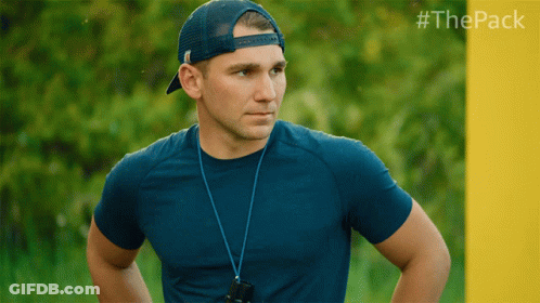 Man In Blue Shirt And Hat In Front Of Yellow Wall With #Thepack GIF
