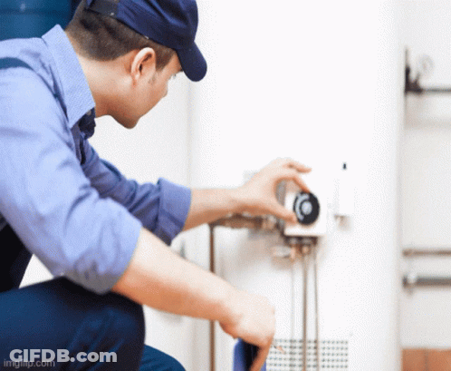 Man In Blue Shirt And Hat Working On Thermostat GIF