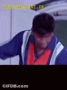Man In Blue Shirt And Red Vest GIF