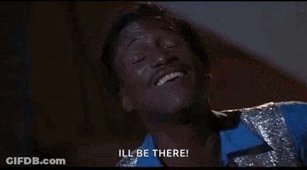 Man In Blue Shirt And Silver Jacket Smiling Saying Ill Be There GIF