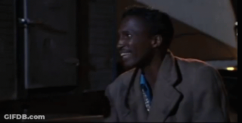 Man In Blue Shirt And Silver Vest Smiling GIF
