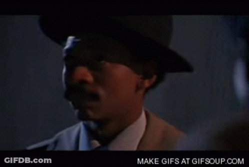 Man In Blue Shirt And Silver Vest Smiling GIF
