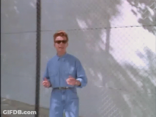 Man In Blue Shirt And Sunglasses At Fence GIF