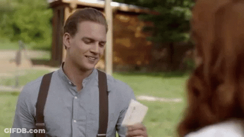 Man In Blue Shirt And Suspenders Holding Paper GIF