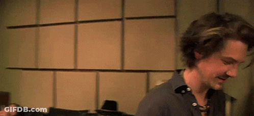 Man In Blue Shirt And Suspenders Smiling GIF