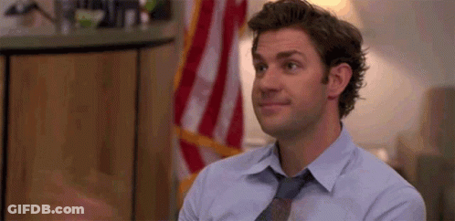 Man In Blue Shirt And Tie Before American Flag GIF