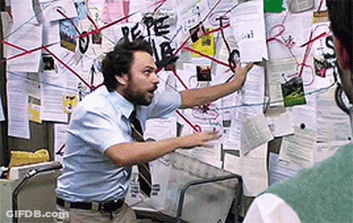 Man In Blue Shirt And Tie Before Bulletin Board GIF